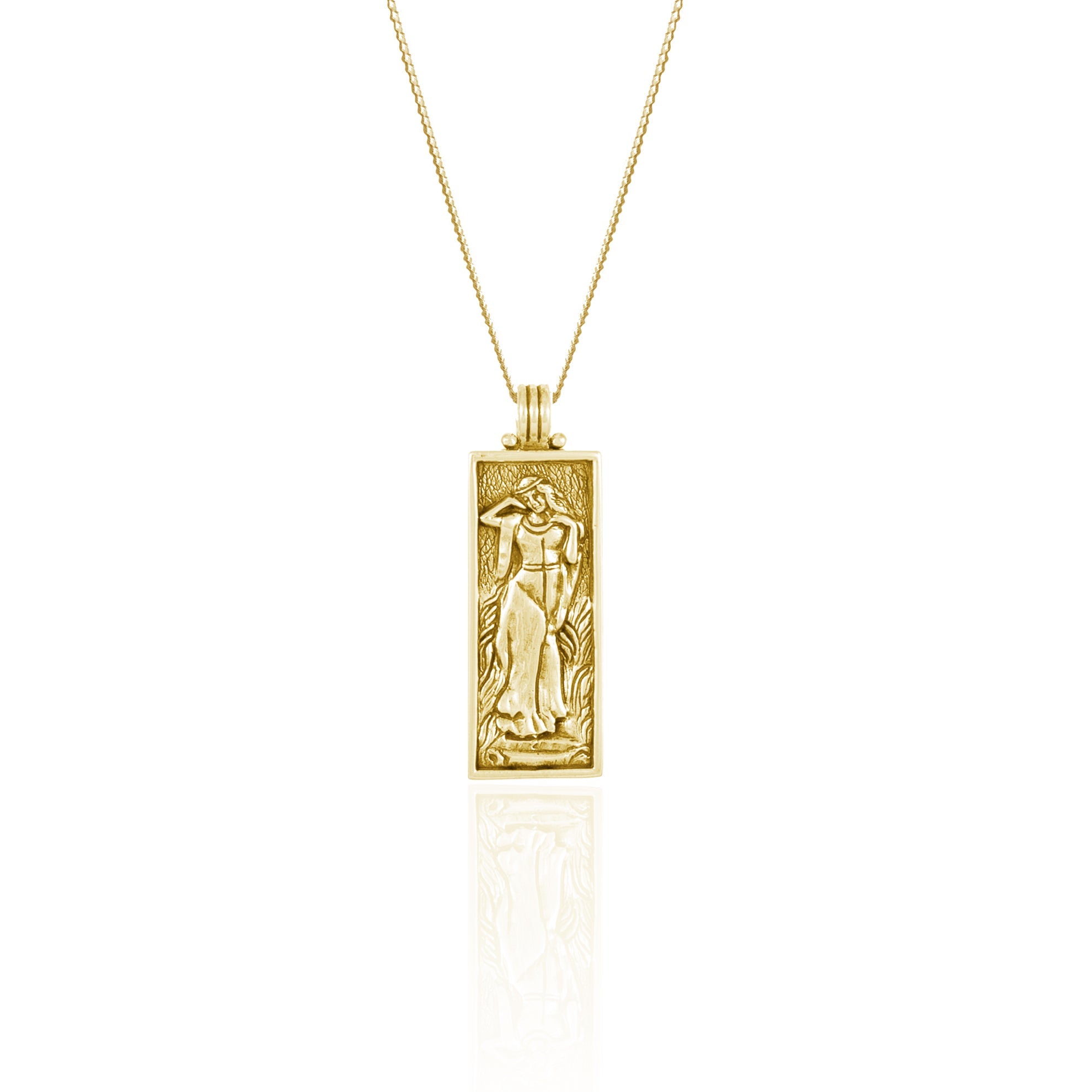 A gold necklace with a rectangular pendant featuring a raised figure design, displayed against a white background.