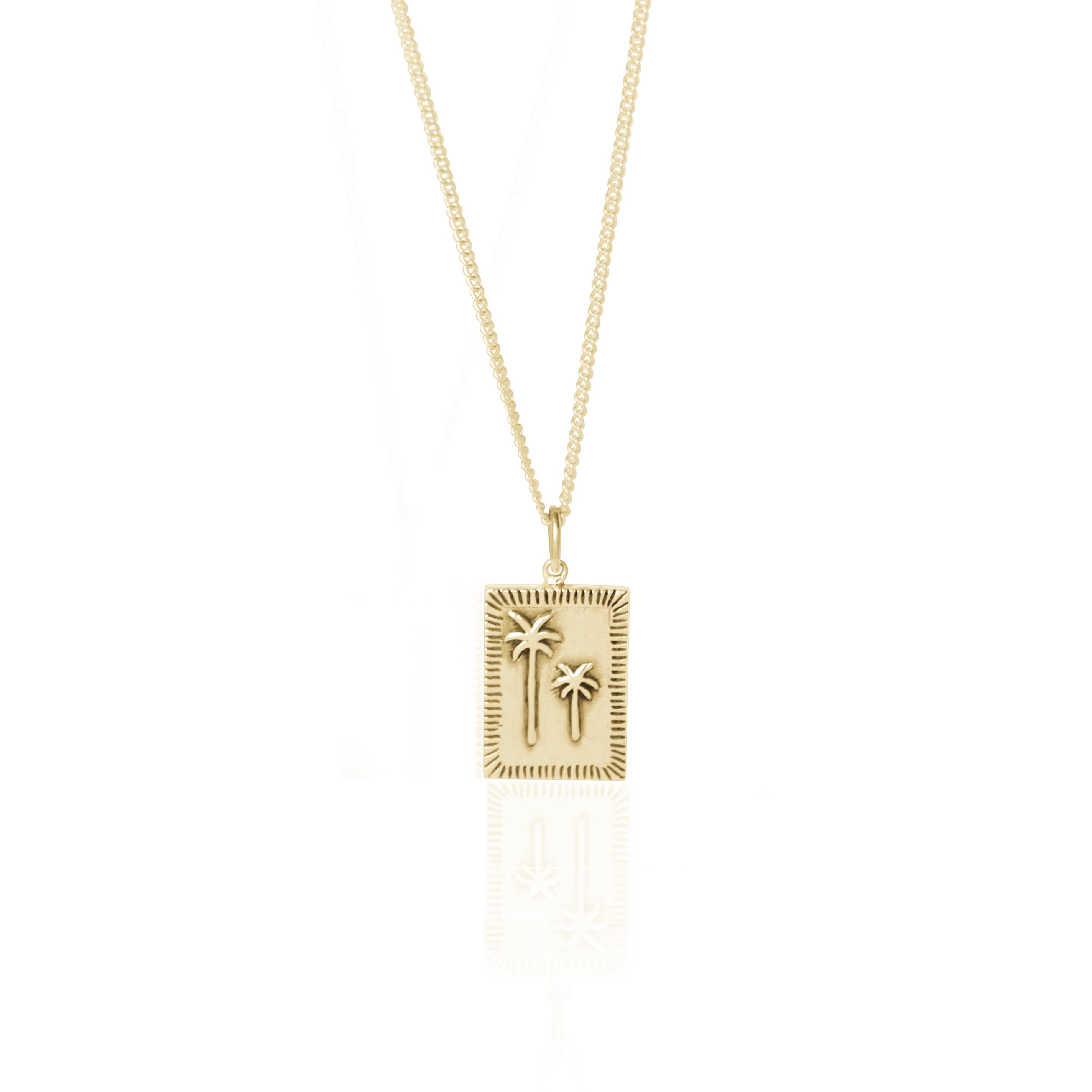 Gold necklace with a rectangular pendant featuring two raised palm tree designs, displayed against a white background.