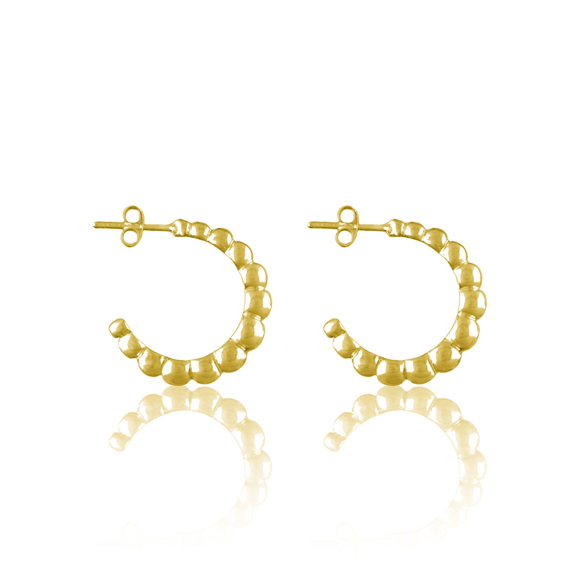 Golden earrings on a white background