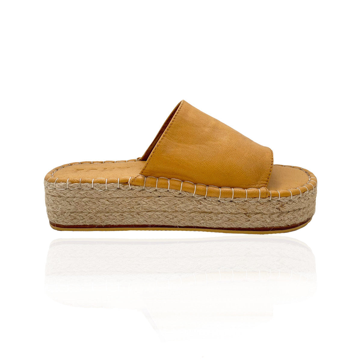 A side profile of a ochre yellow platform sandal with a woven sole on a white background.