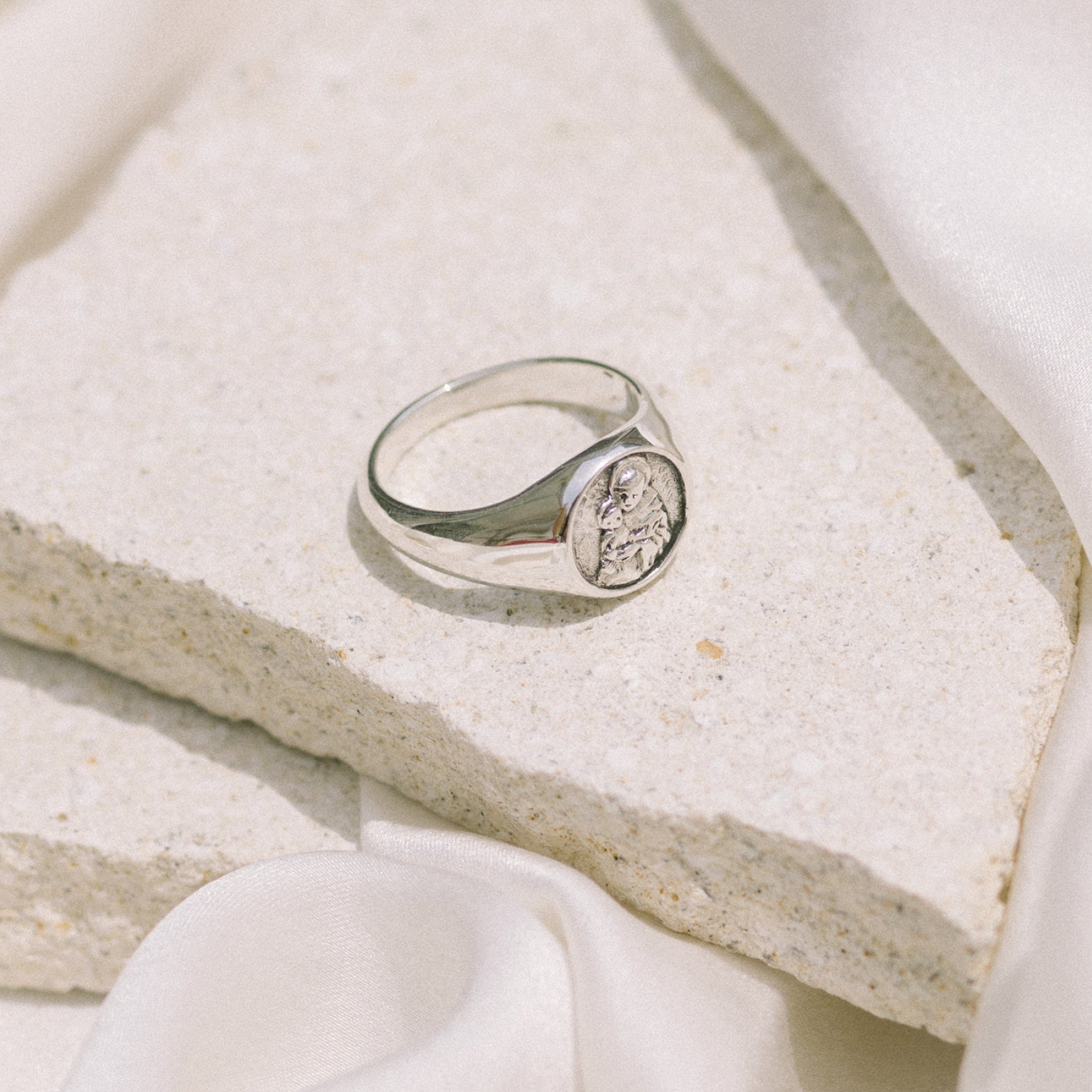 a signet ring silver displayed on stone