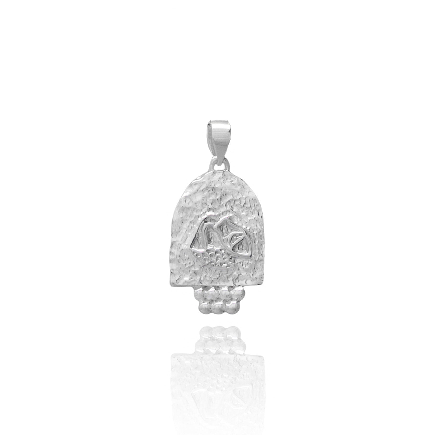 A silver pendant featuring an engraved design on a white background.
