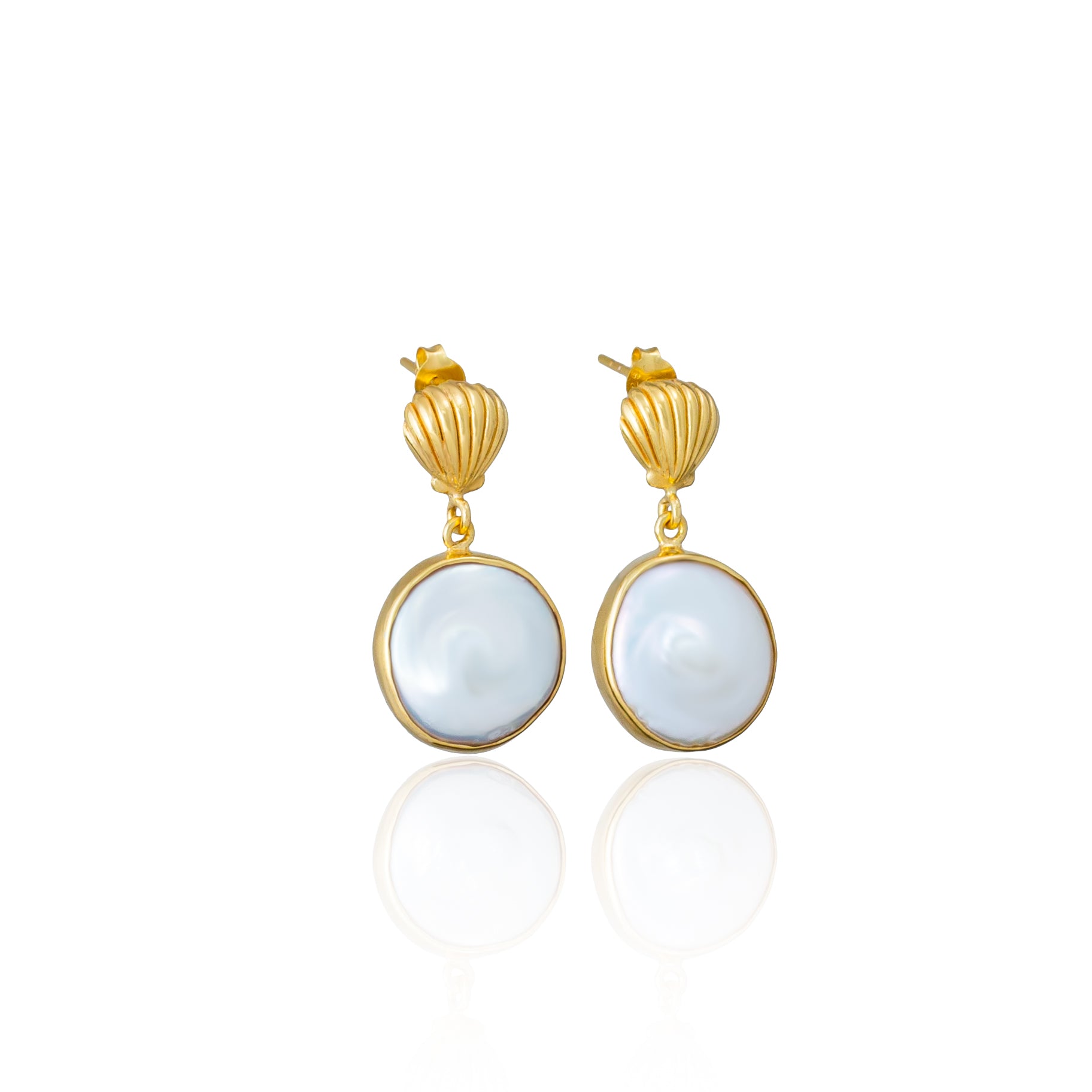 A pair of gold drop earrings with large white pearl pendants against a white background.