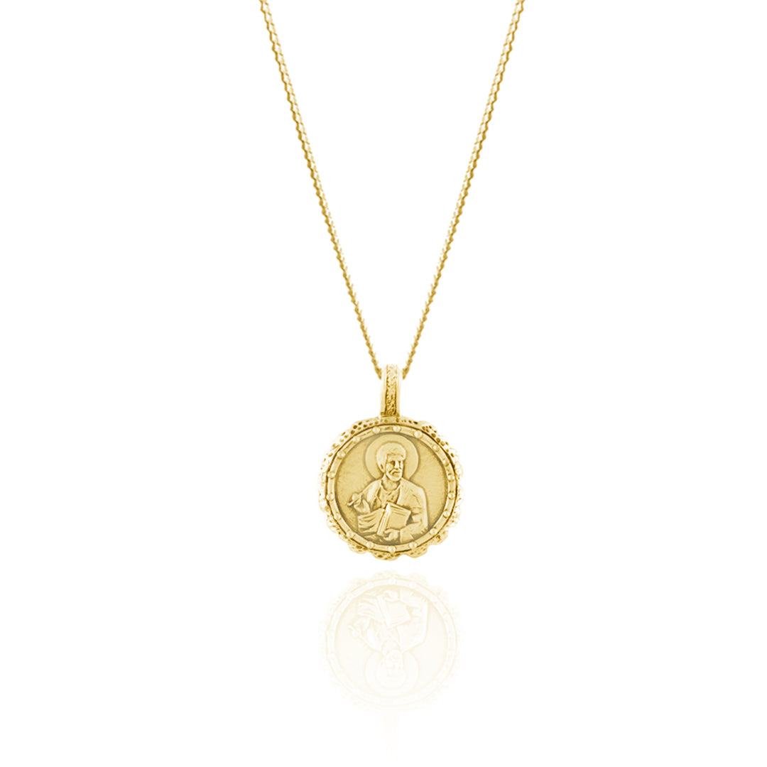 A gold pendant necklace featuring an intricate design of the saint of Creativity & Artists
