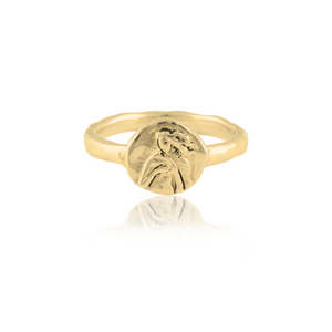 A gold ring featuring an intricately detailed depiction of a saint figure on its face.