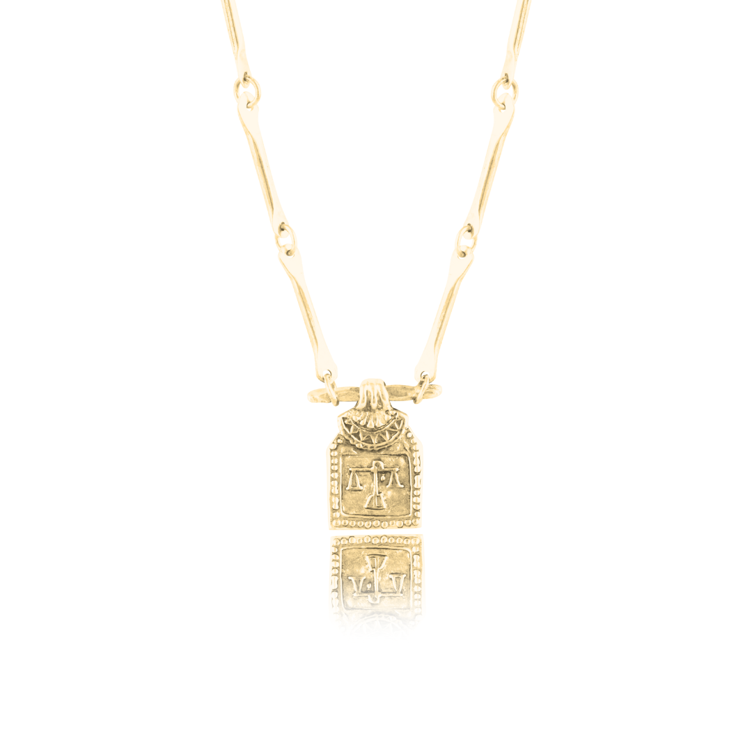 Golden necklace with pendant of libra zodiac sign