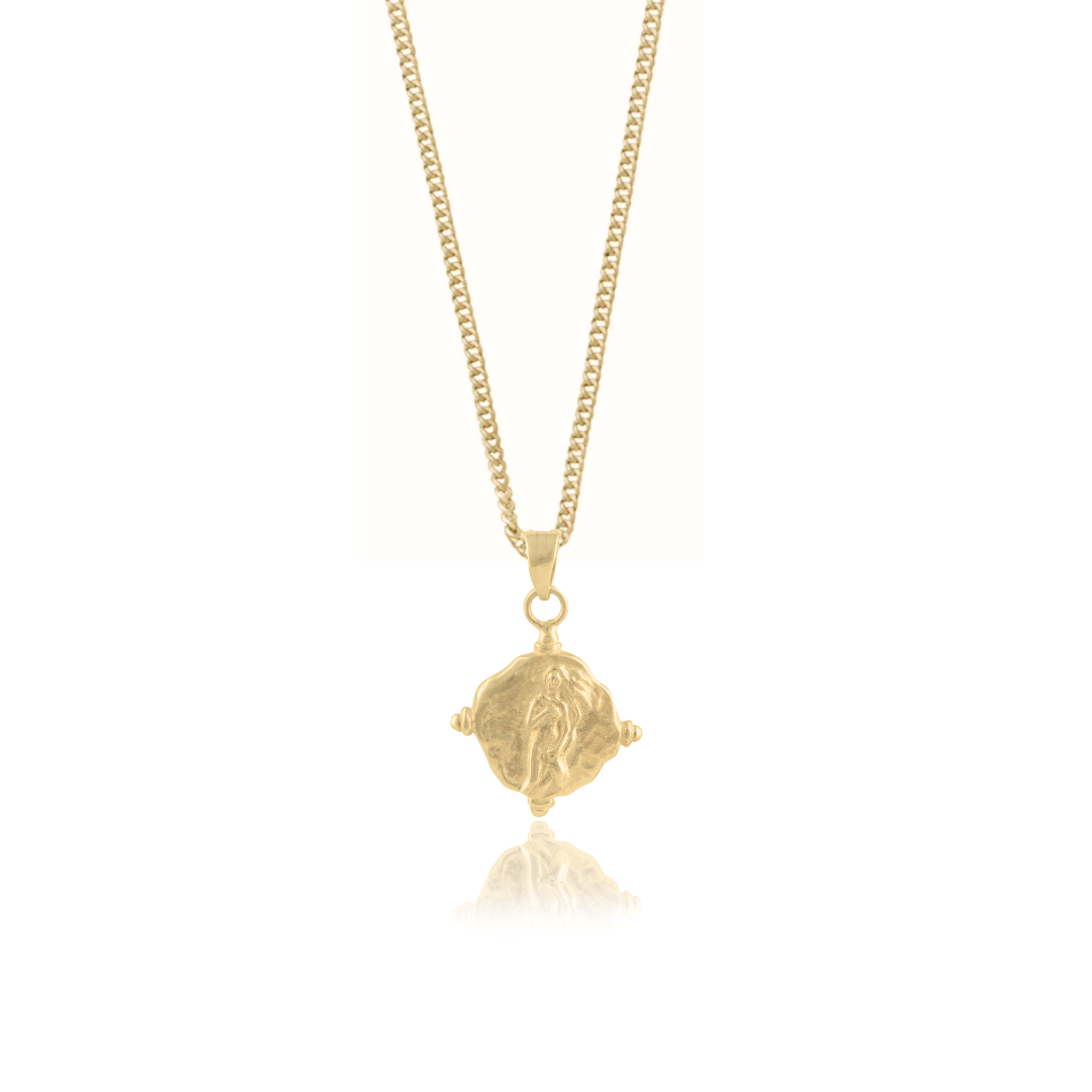 A gold necklace with a pendant featuring a religious figure designs design.