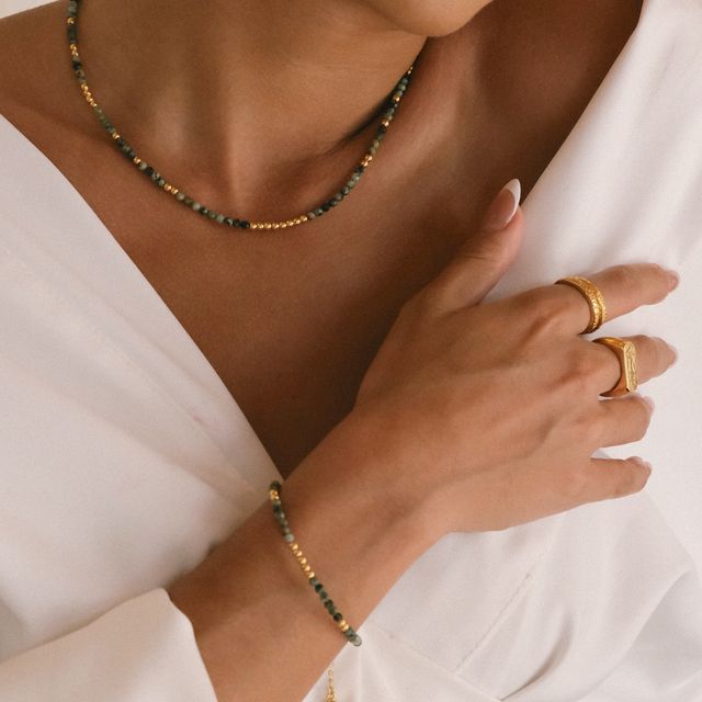 a woman with Close-up of a bracelet with small beads