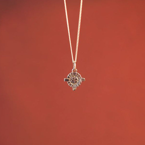 Close-up of a hanging mini St. Dymphna charm
