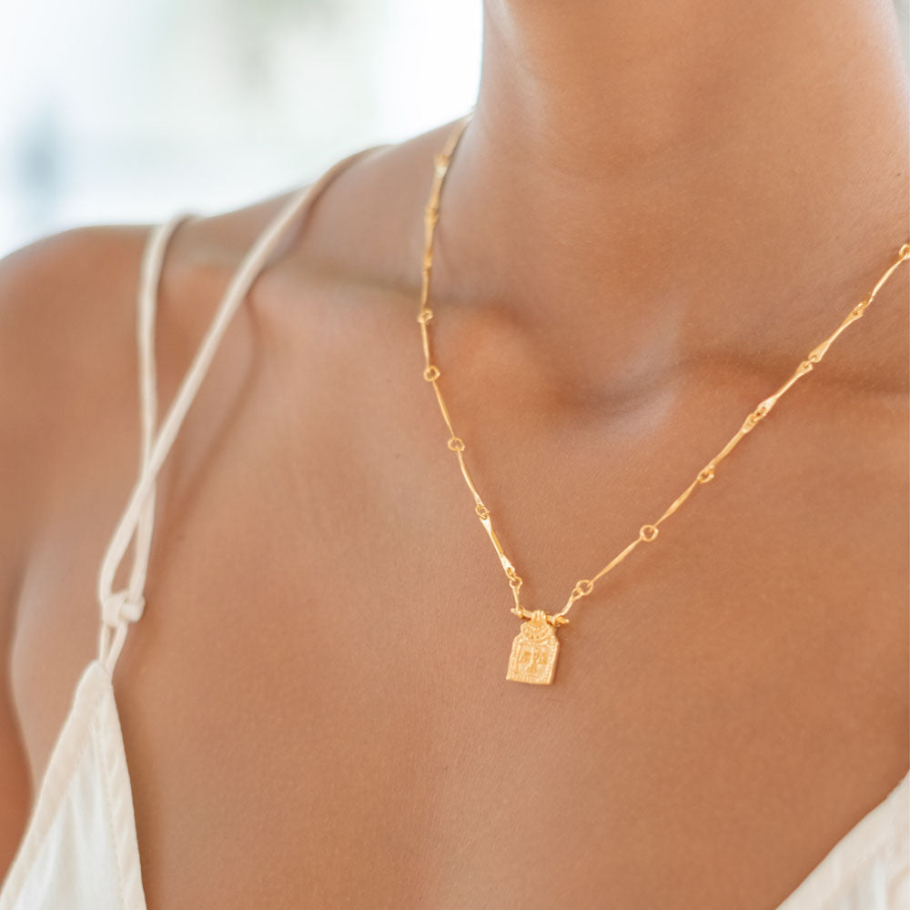 Golden necklace with pendant of libra zodiac sign