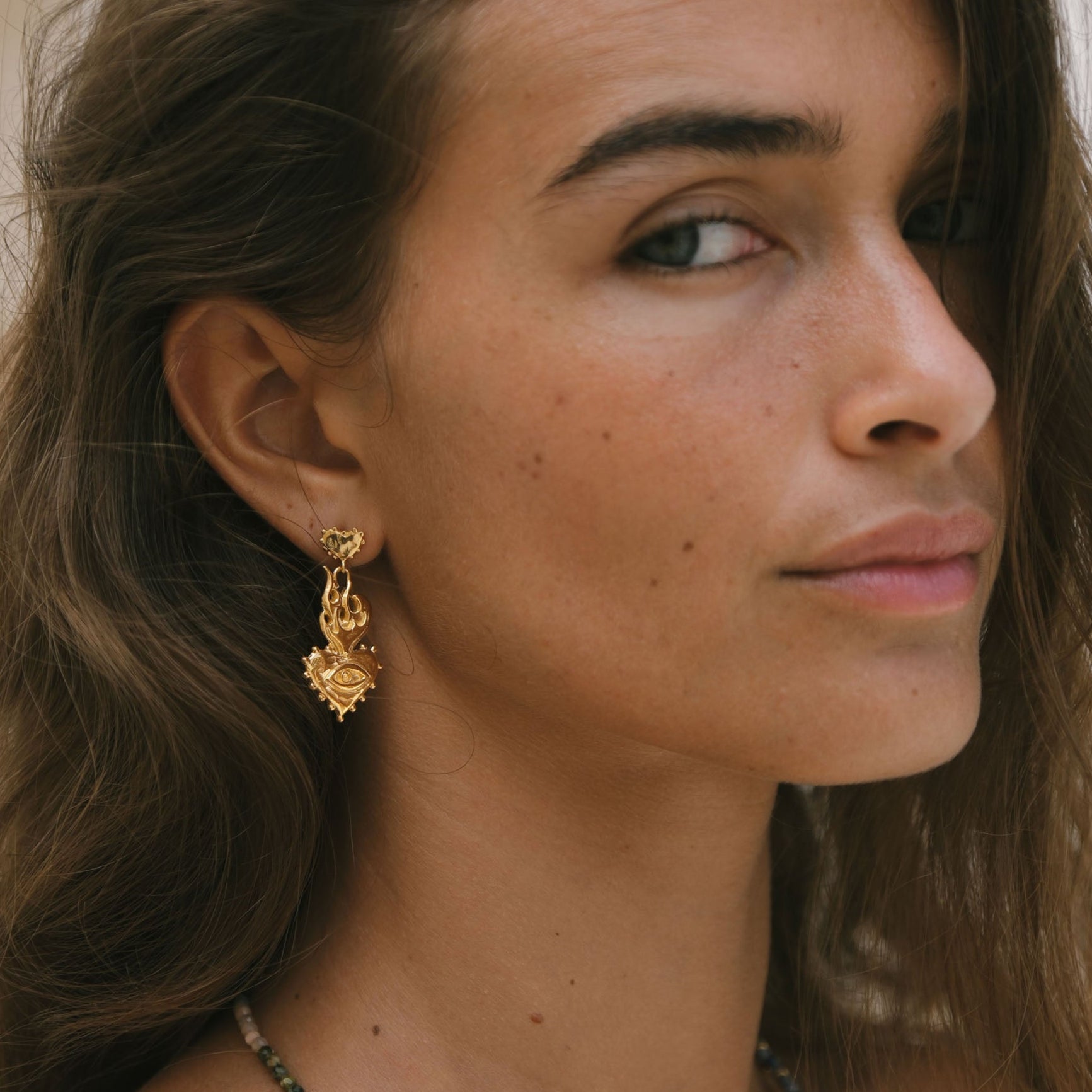 Handmade Luna & Rose x Tahnee Kelland ‘Burn It All Down’ gold heart-on-fire statement earrings, crafted in Bali from recycled sterling silver side angle