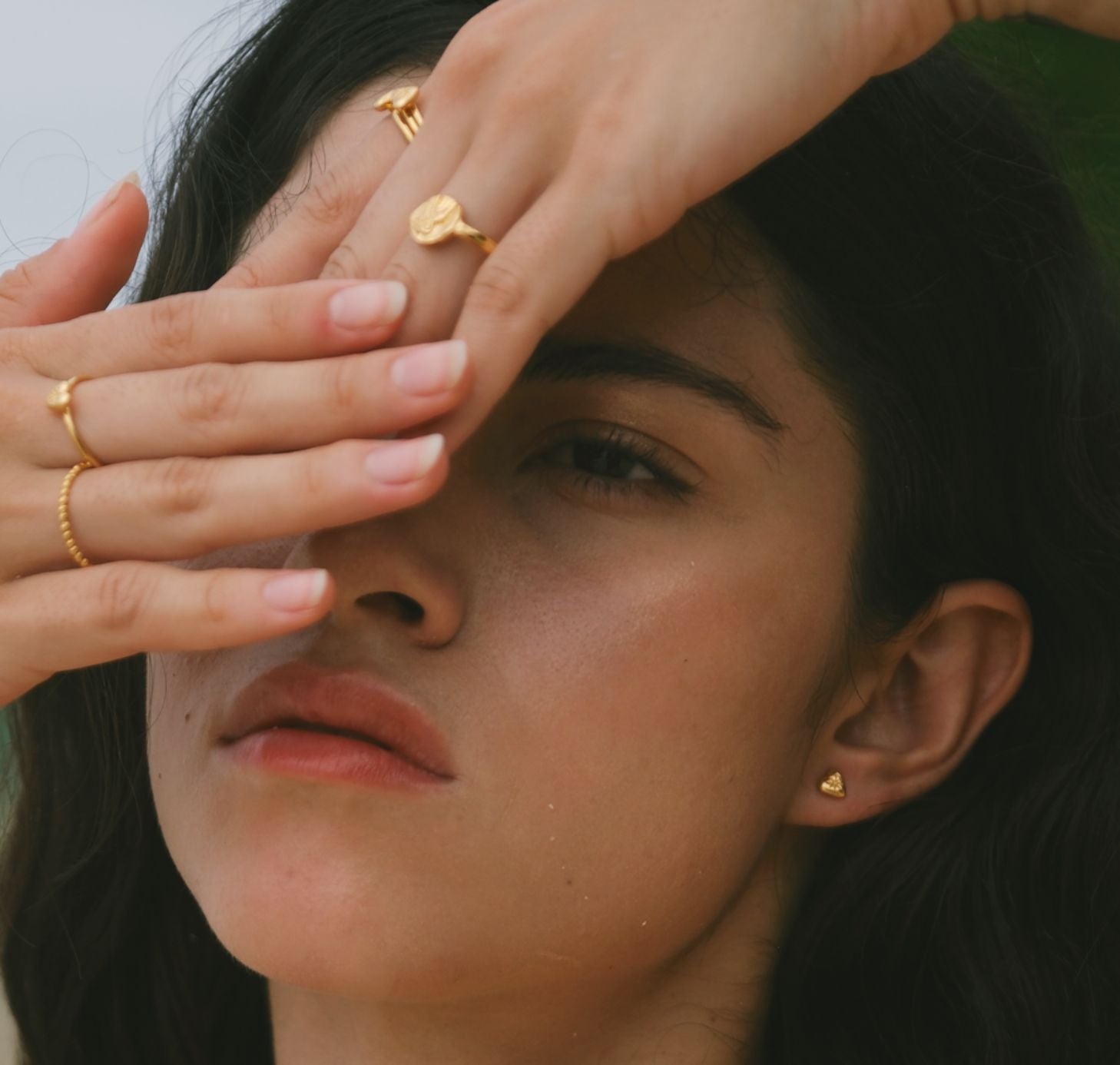 Beautiful Model wearing tiny Gold heart stud earrings