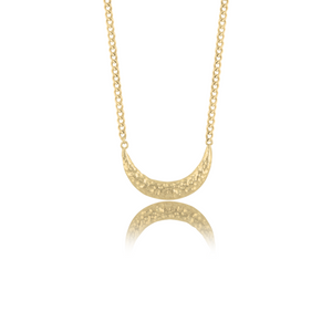 Close-up of a gold necklace with a crescent moon pendant displayed against a white background.