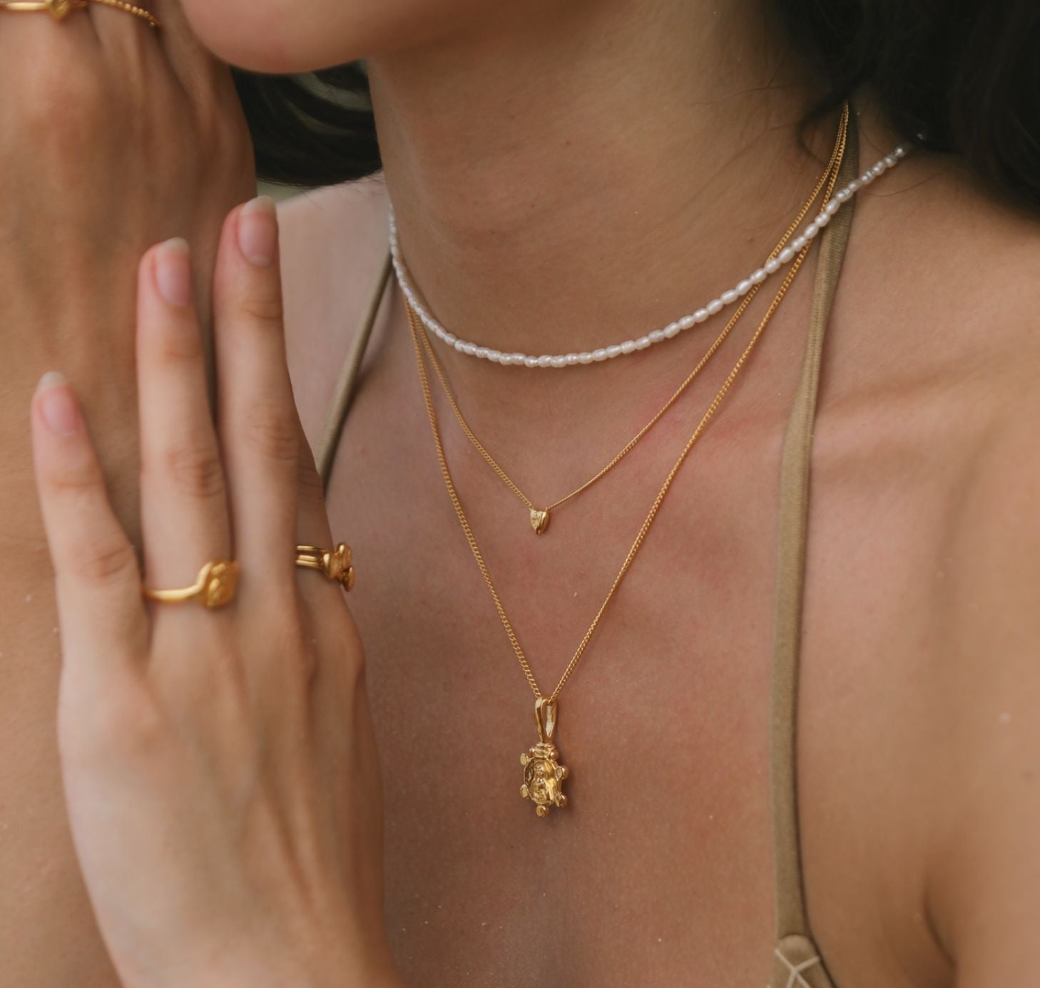 Gold necklaces layering with ert pearls and St Valentine