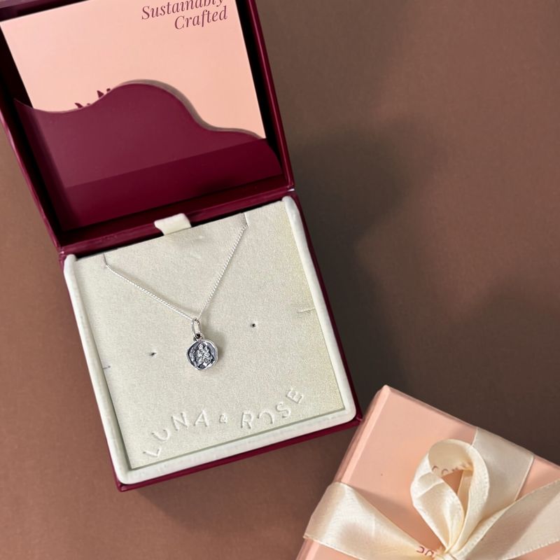 Minimalist mini St. Christopher necklace showcased in jewelry box