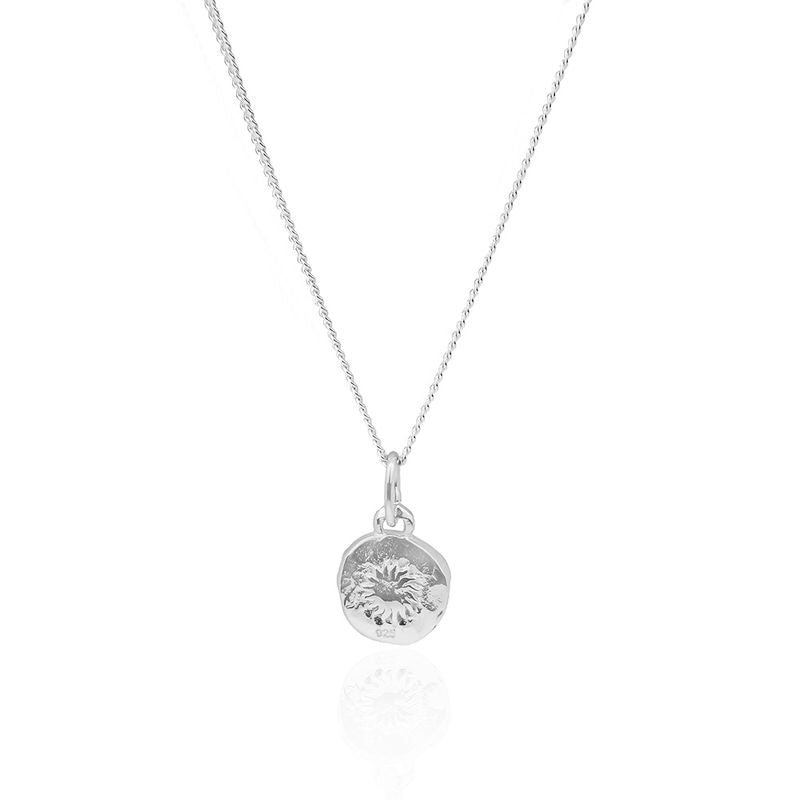Minimalist mini St. Christopher necklace showcased on a white surface