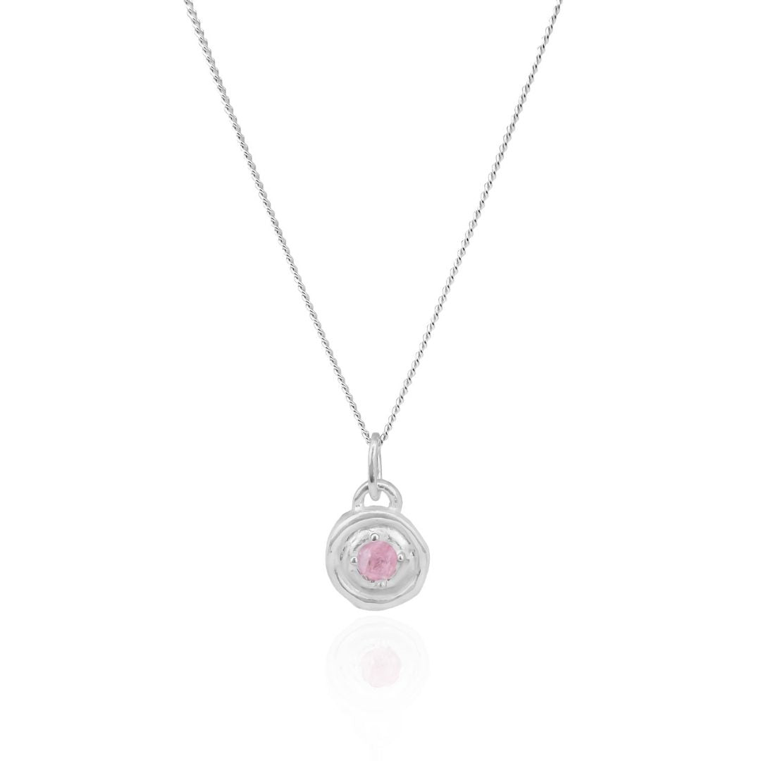 Silver necklace with a pink gemstone pendant on a white background