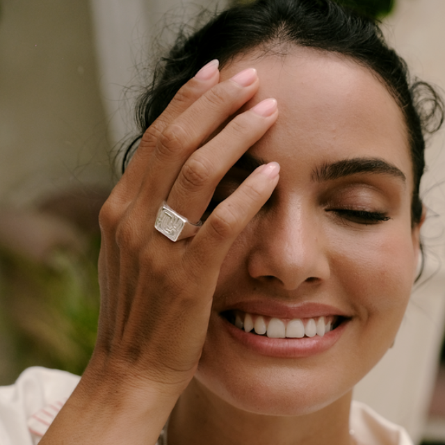 Portrait of a woman in a white shirt wearing silver ring by luna rose