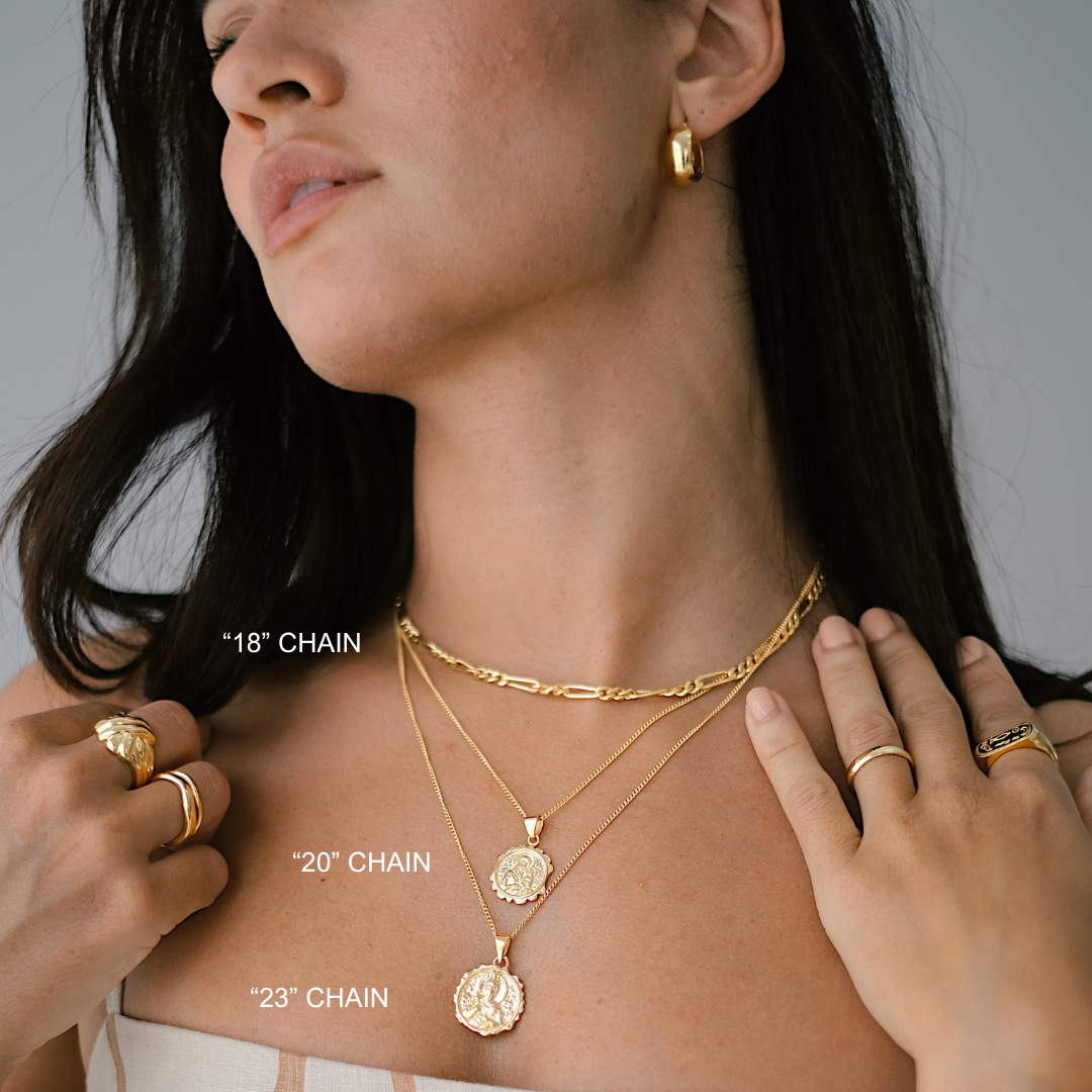Woman wearing gold necklaces with labeled chain lengths on a neutral background