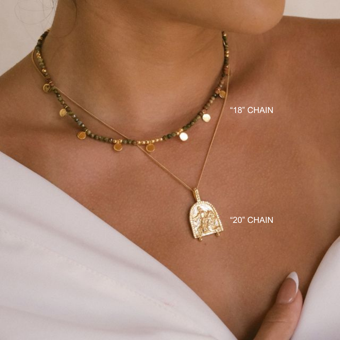 Gold necklace with pendant on a person's neck, showing chain lengths.