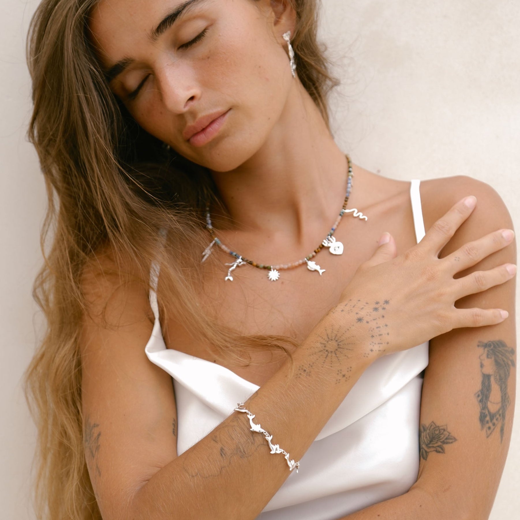 Handmade Luna & Rose x Tahnee Kelland ‘Vibes Don’t Lie’ silver bracelet, dolphin design symbolising flow, crafted sustainably in Bali on Model