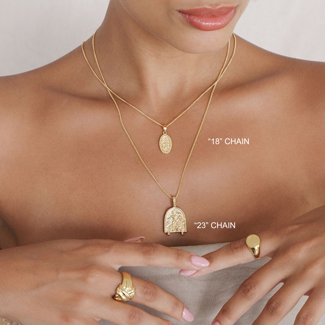 Gold necklaces and rings on a person's neck and hands with chain lengths labeled.