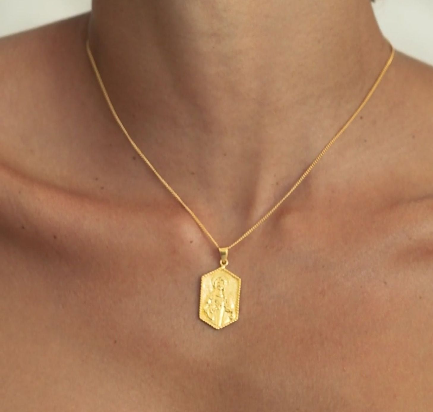 a woman wearing St Dwynwen - Saint of Love pendant gold