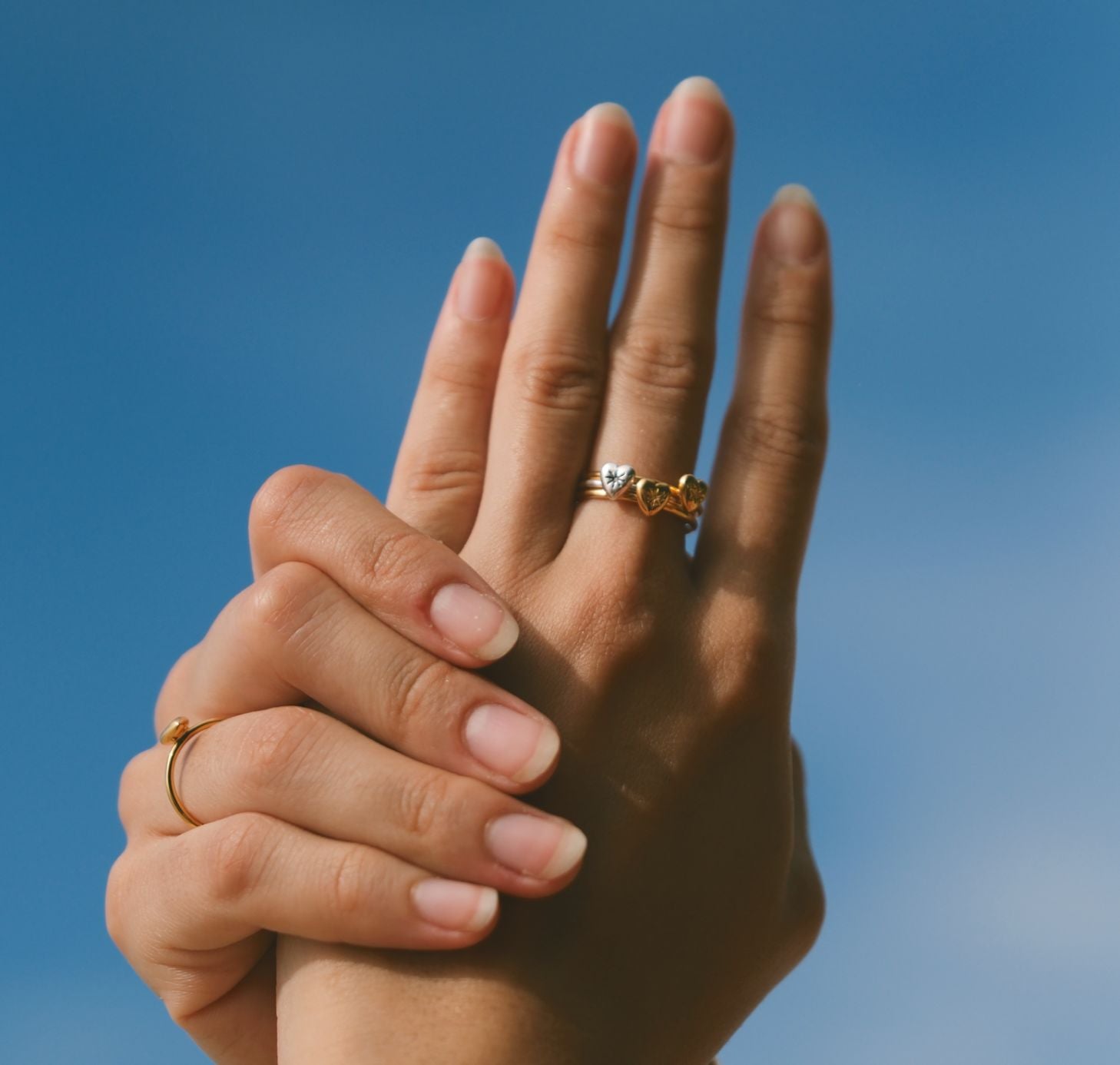 Three Mini heart rings stacked on finger by Luna & Rose Bali jewellery brand