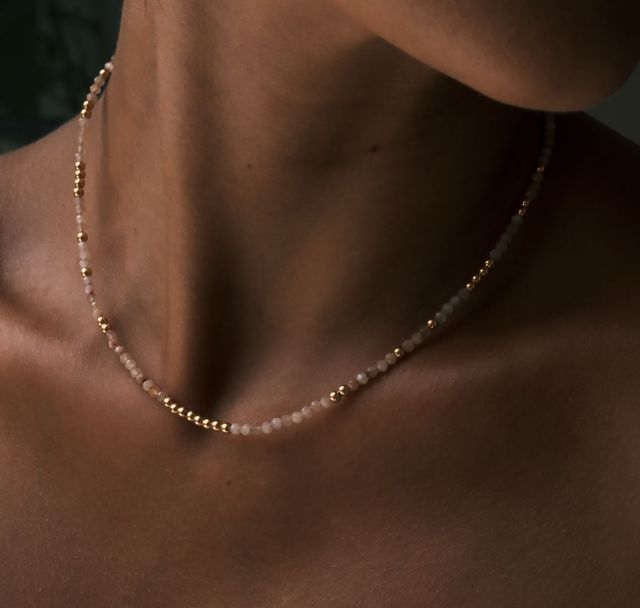 a woman wearing The Billy Blush Necklace Gold by Luna and Rose Bali 