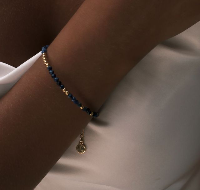 a woman wearing The Indigo Tide Bracelet Gold by Luna and Rose Bali