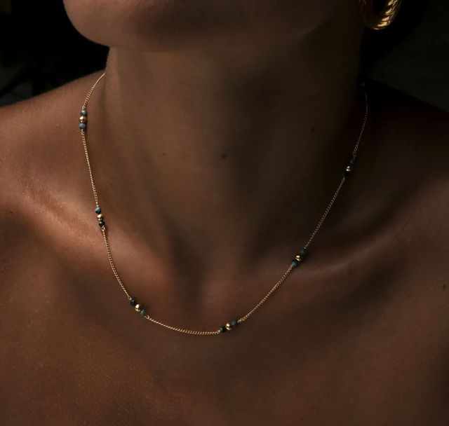 a woman wearing The Quinn Necklace Gold by Luna and Rose 