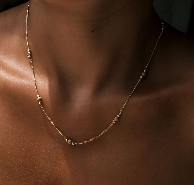 a woman wearing The Sunstone Necklace Gold by Luna and Rose Bali 