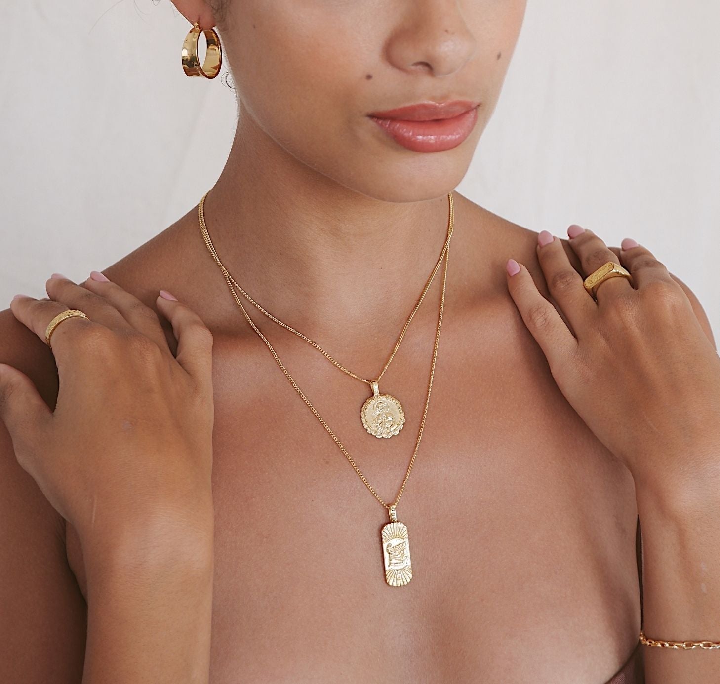 a woman wearing St Luke necklace gold and Truth & Good Luck Necklace (Reversible) -  Gold