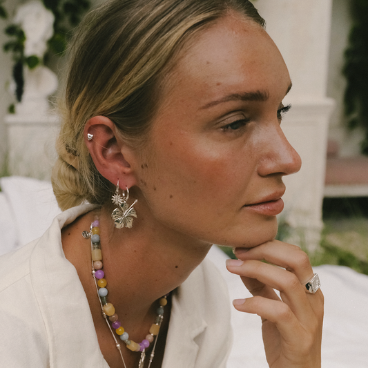 Woman enjoying a sunny day while wearing delicate silver accessories