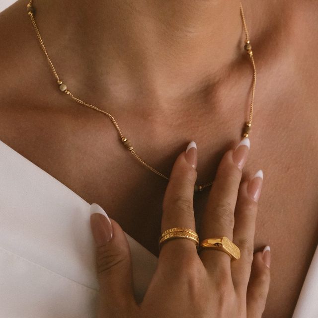 a woman touched her necklace