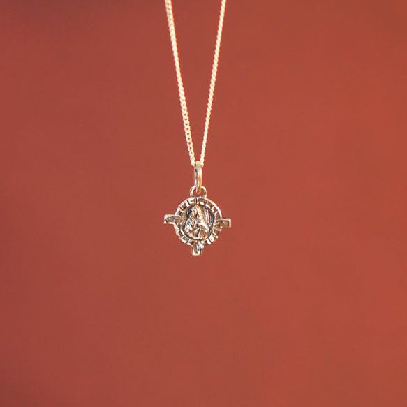 front side of mini St Dymphna charm silver