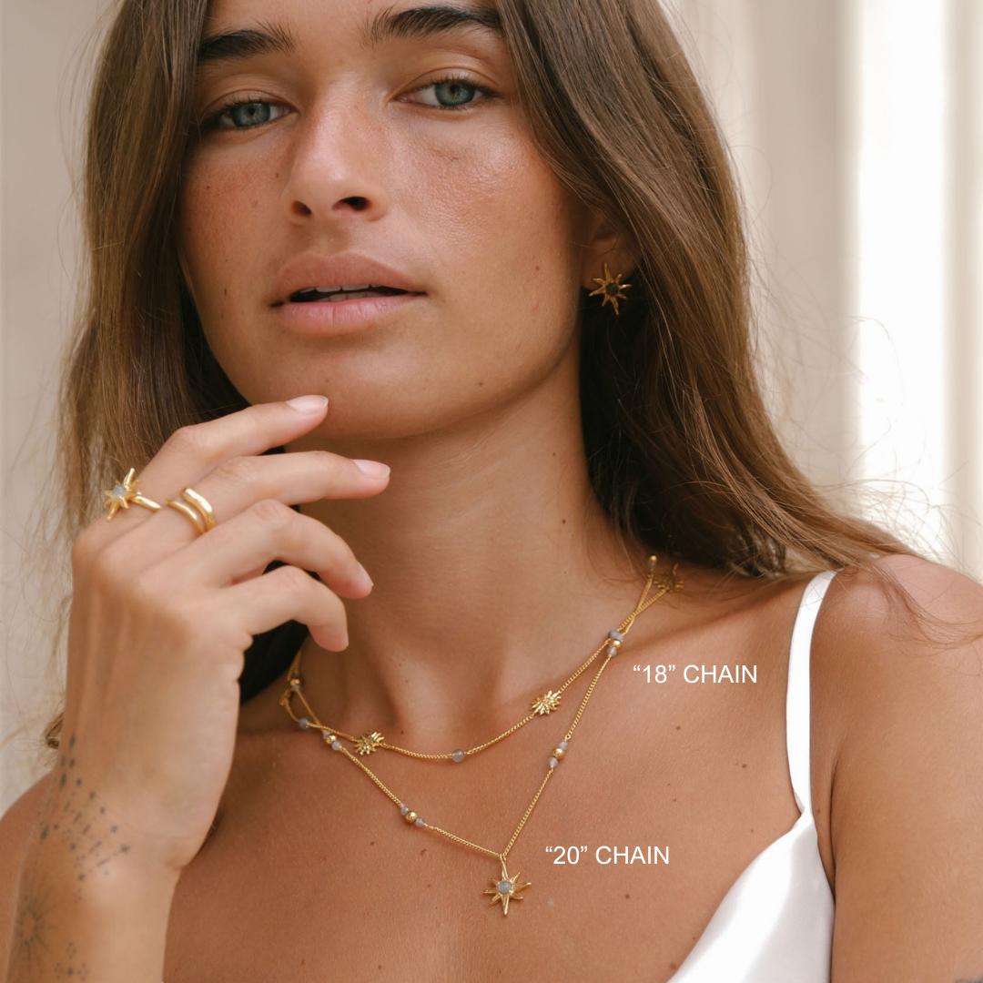 Woman wearing gold necklaces with '18' chain and '20' chain labels.