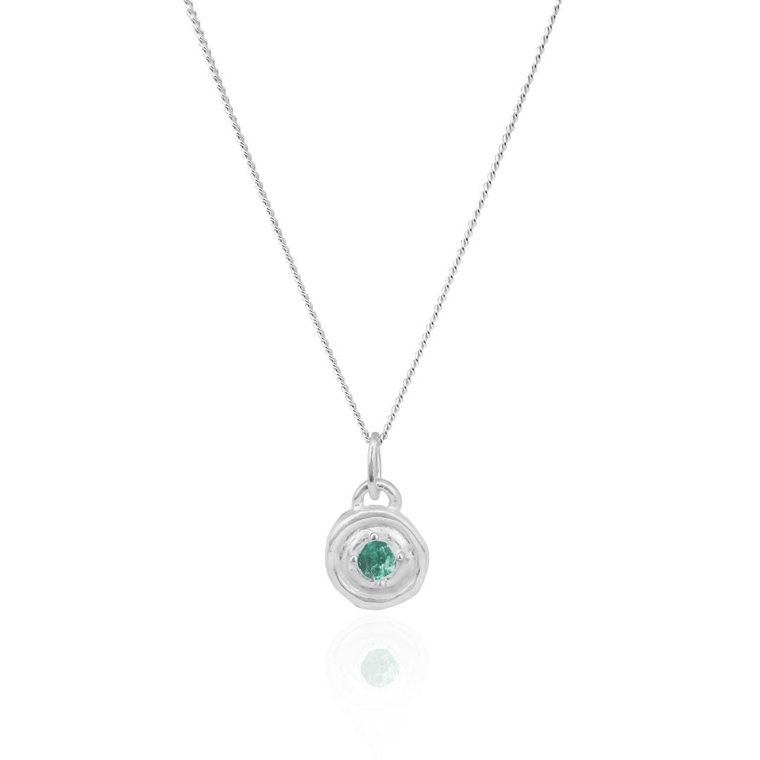 Silver necklace with a green gemstone pendant on a white background