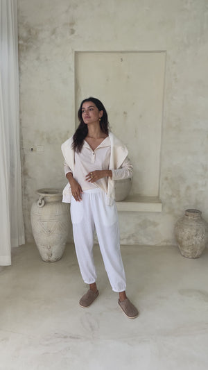 A person wearing white loose-fitting pants showing it from every side in a video