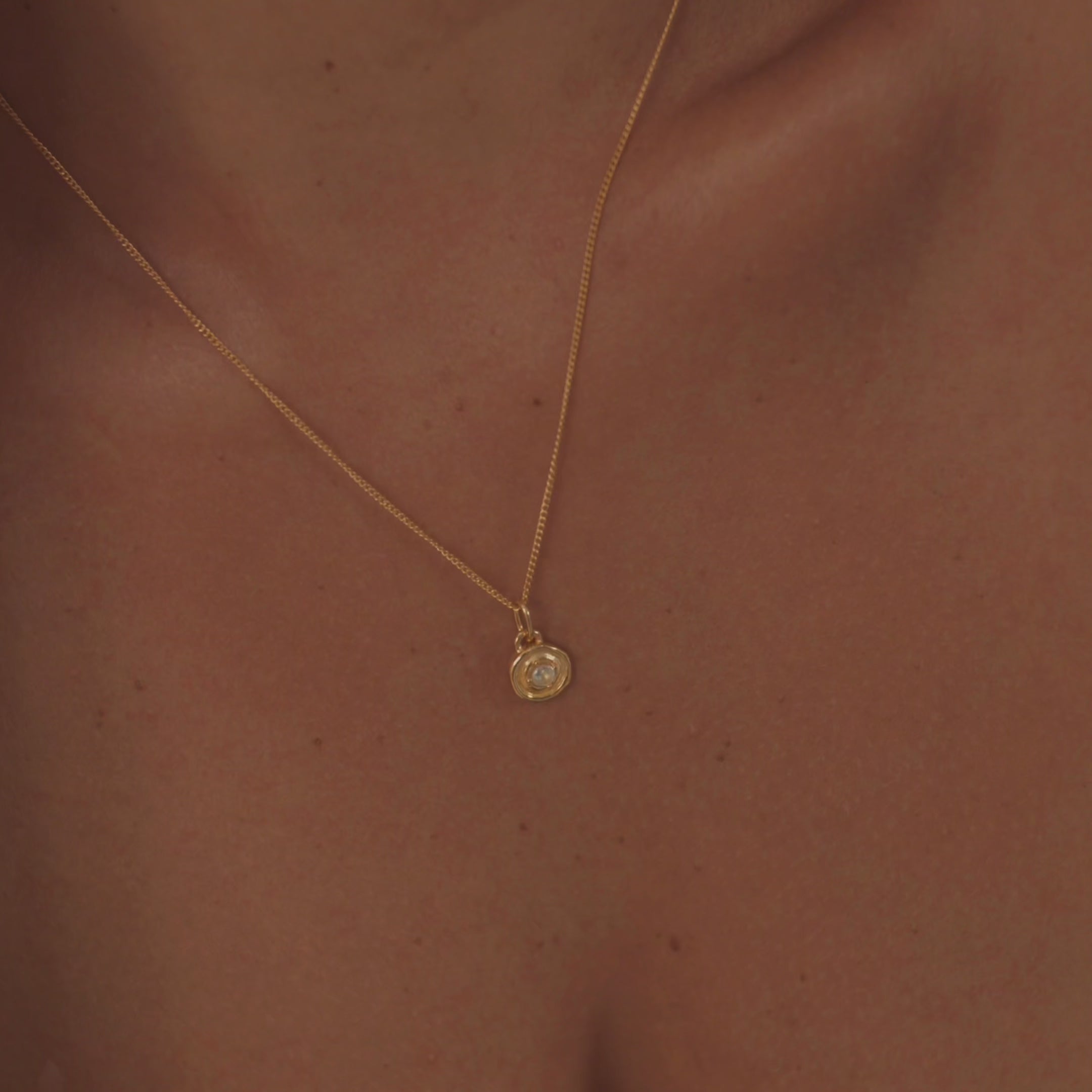 "A model wearing a stunning aquamarine necklace, highlighting the gemstone's serene, sea-blue color and crystal-clear sparkle.