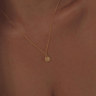"A model wearing a stunning aquamarine necklace, highlighting the gemstone's serene, sea-blue color and crystal-clear sparkle.
