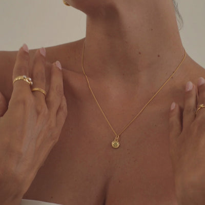 A model wearing a stunning peridot necklace, highlighting the gemstone's vibrant lime-green hue and natural luminosity.