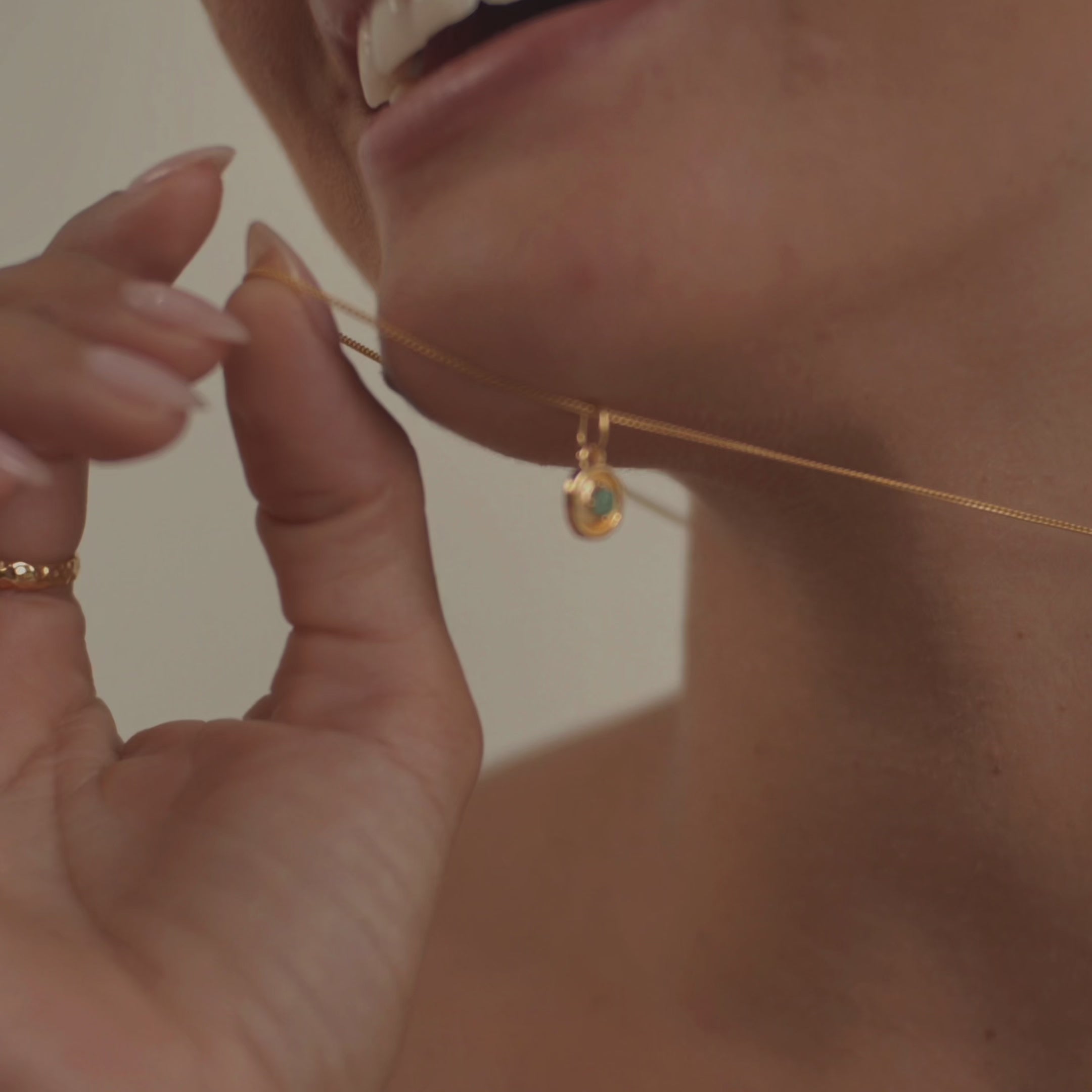 A model wearing a stunning emerald necklace, highlighting the gemstone's rich, vivid green hue and natural radiance