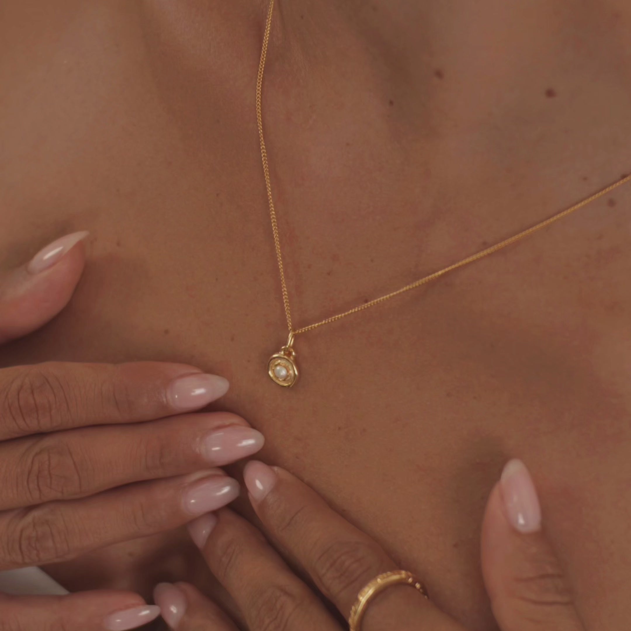 A model wearing a stunning pearl necklace, highlighting the gem's delicate sheen and timeless style.