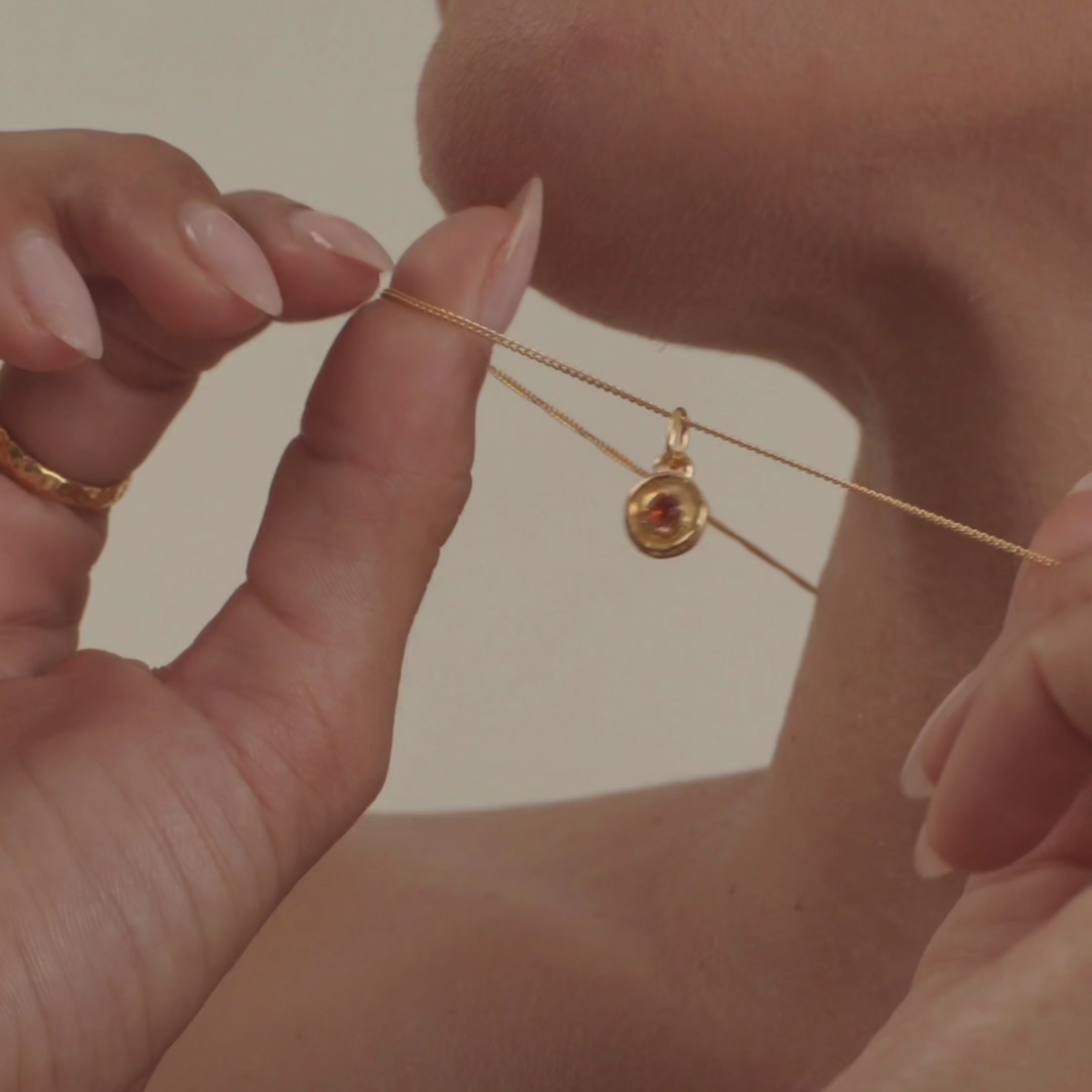 A model wearing a stunning ruby necklace, highlighting the gemstone's deep, passionate red color and radiant shine.