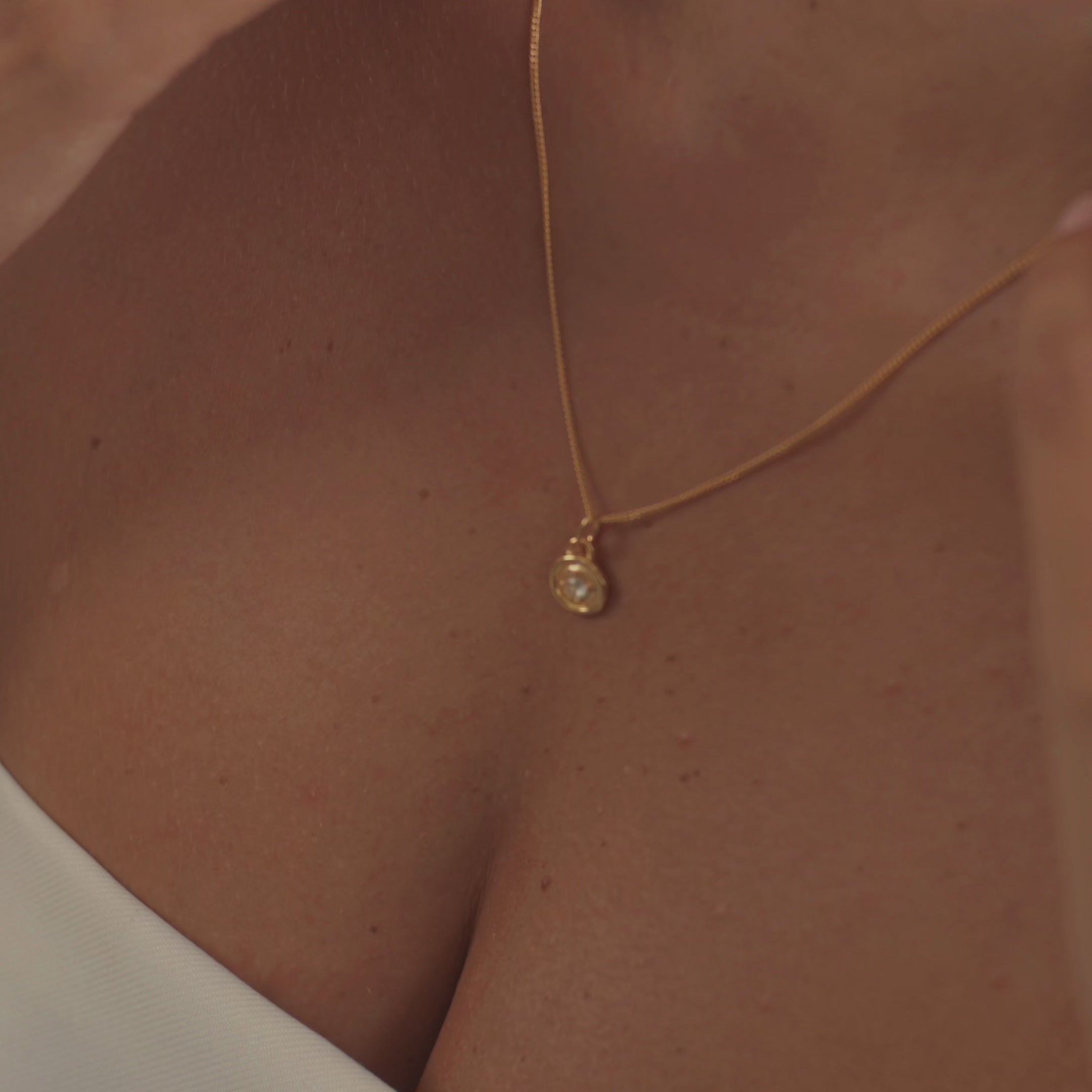 A model wearing a stunning diamond necklace, capturing the gemstone's brilliant fire and unmatched sparkle as it moves.