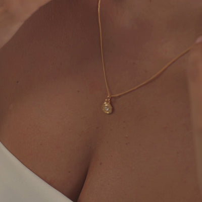 A model wearing a stunning diamond necklace, capturing the gemstone's brilliant fire and unmatched sparkle as it moves.