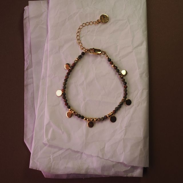 sienna sol bracelet lay on white tissue by luna rose