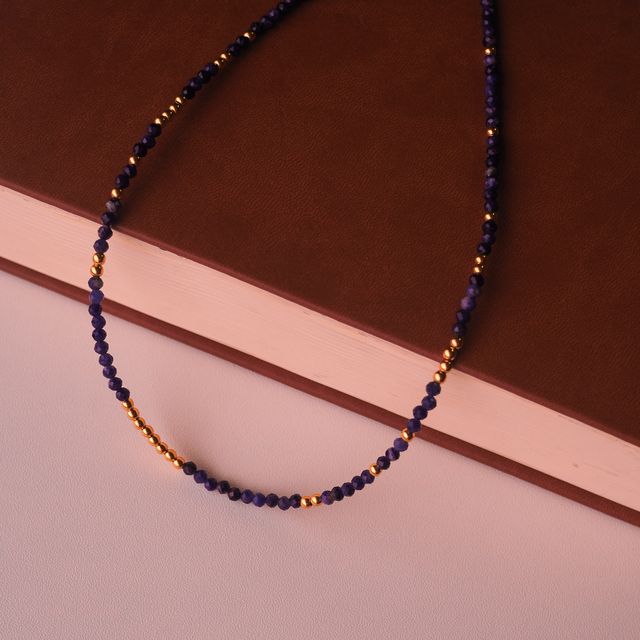 gemstone necklaces styled on a book