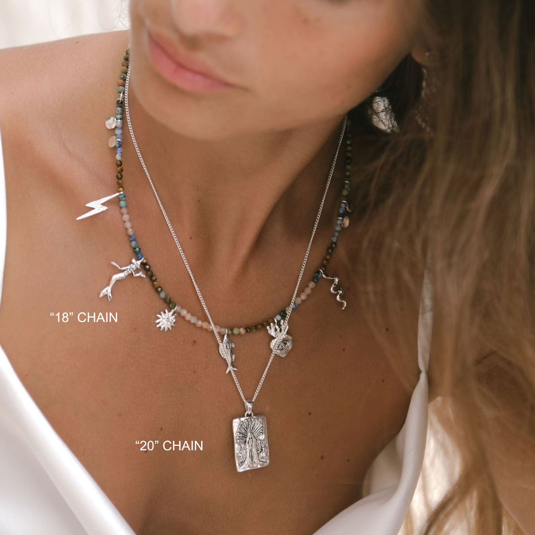 Close-up of a woman wearing two necklaces with different chain lengths, labeled '18' Chain' and '20' Chain'.